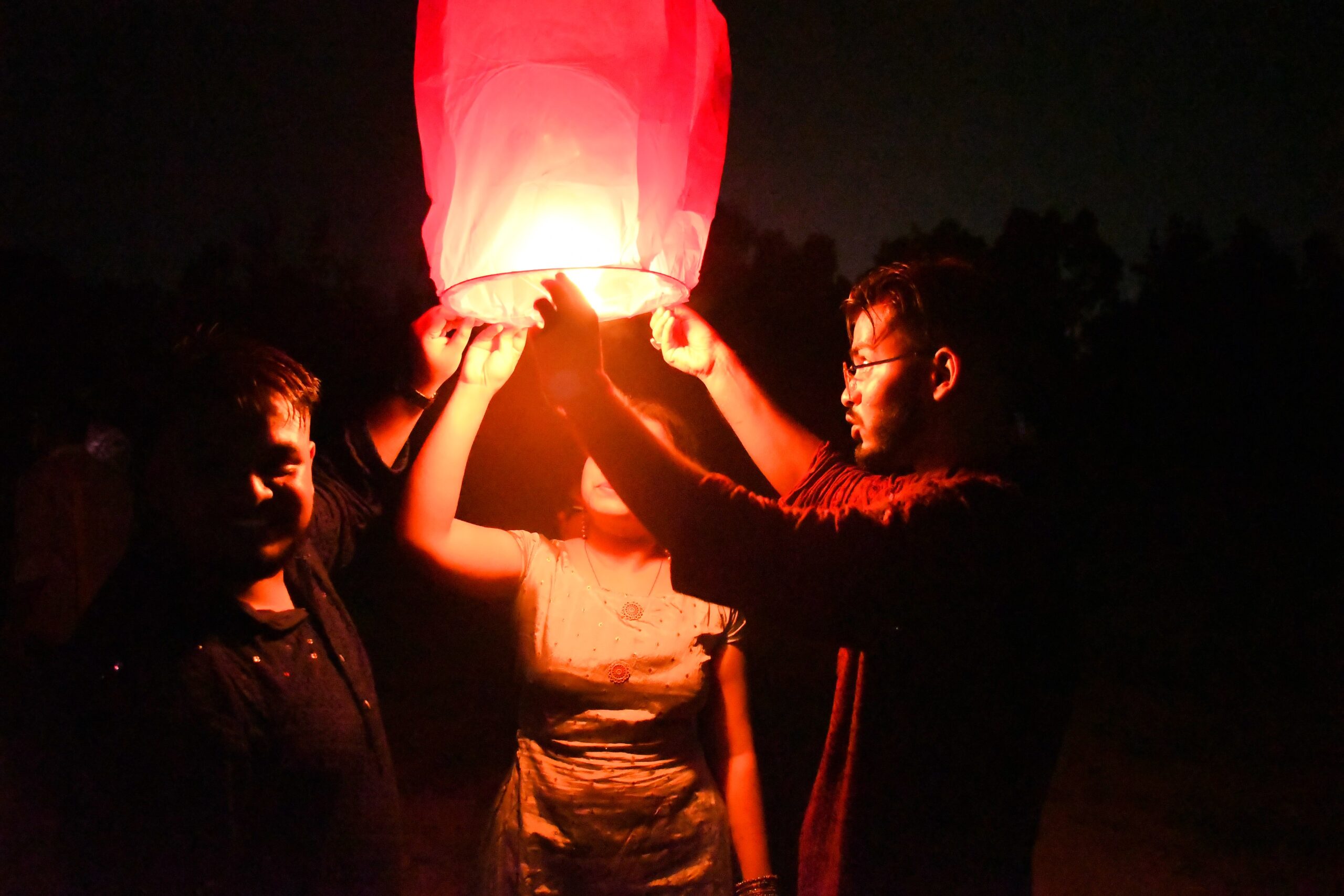RCMB students holding a glowing sky lantern at a Diwali celebration