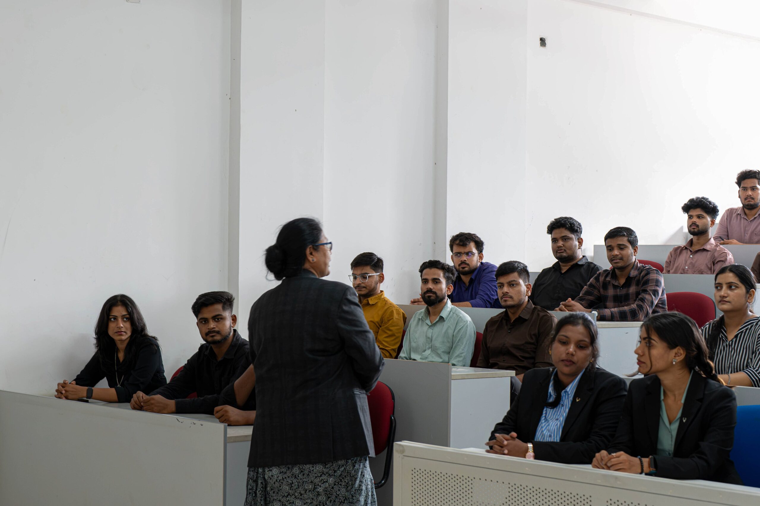 Faculty member discussing ideas with students in a classroom