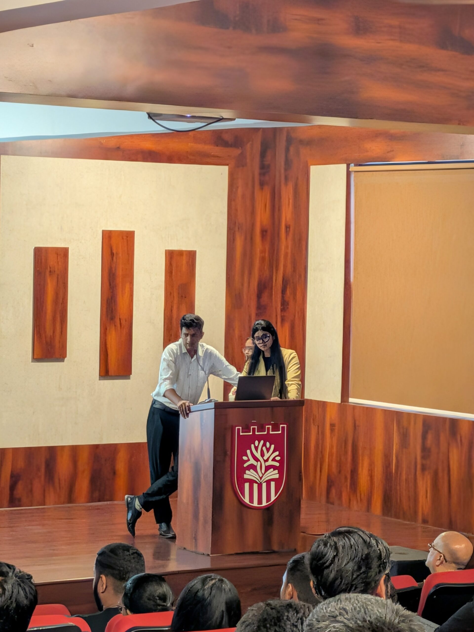 RCMB students presenting together at a podium