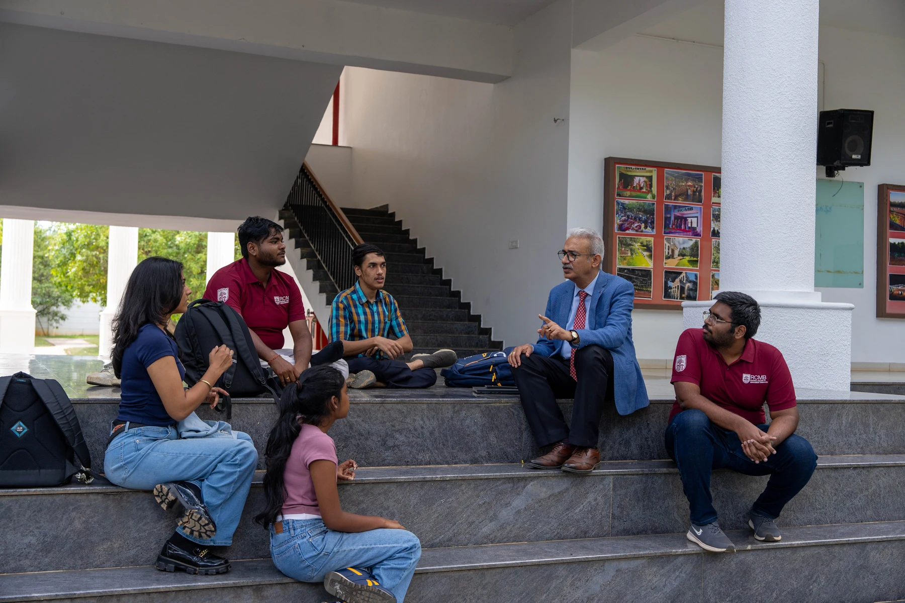 RCMB faculty member mentoring a group of students on the campus steps
